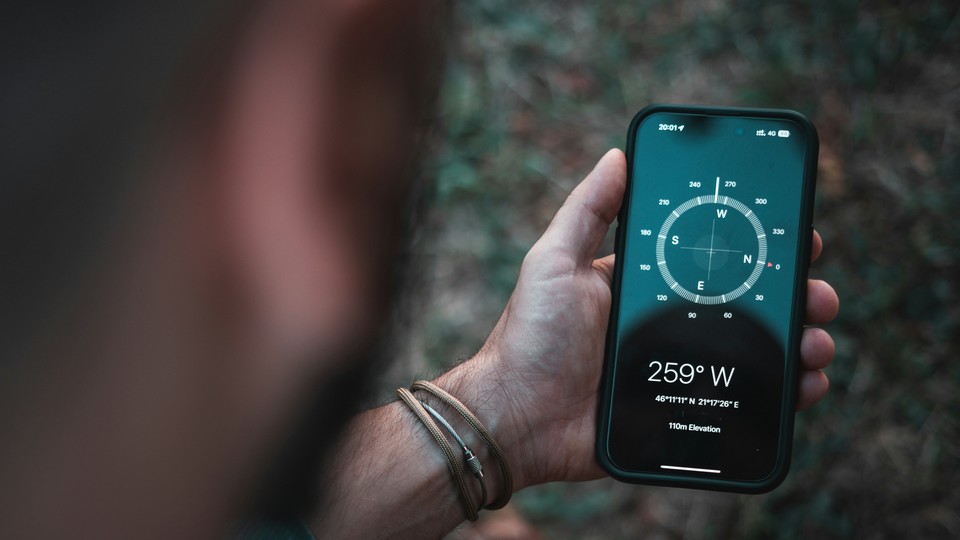 Man looks at compass app on his phone
