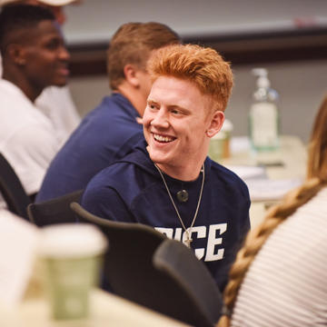 Male student laughing in class